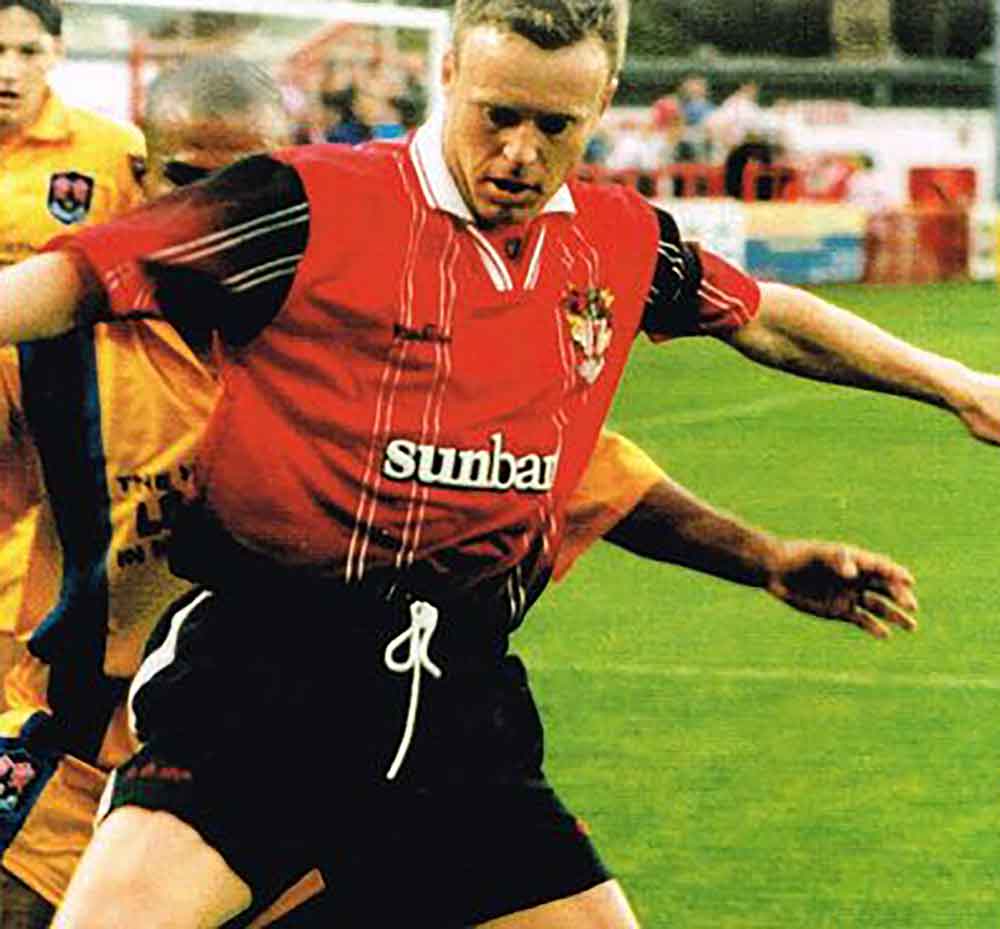 We think this red/black shirt design from 1998-00 was almost ahead of its time; the fading black into red creating a really classy look