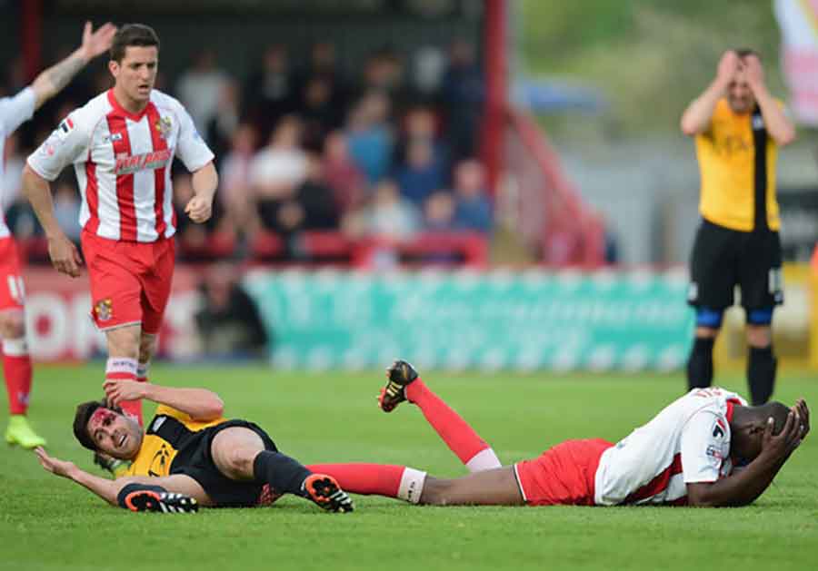 Michael Timlin and Bira Dembele after clashing heads in 2015