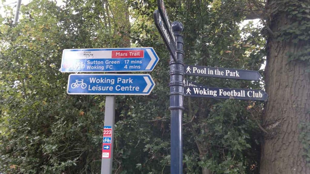 Cycle and pedestrian signs showing way to Woking FC